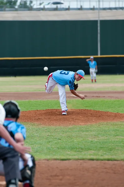 Teen baseball throwing a pitch.