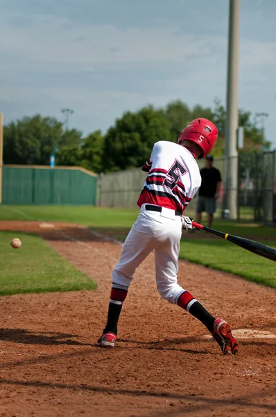 Youth baseball boy swinging bat.