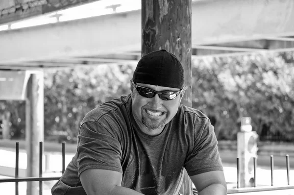 Black and white portrait of man with big smile.