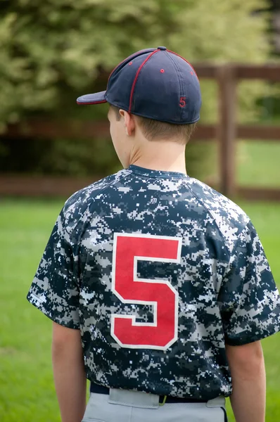 Youth baseball boy from behind