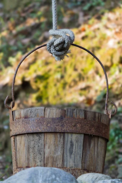 Old wooden bucket at the well