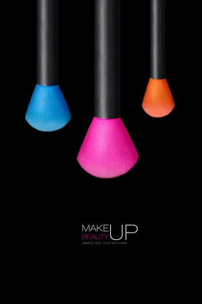 Makeup concept. Colorful Make up brushes over black background