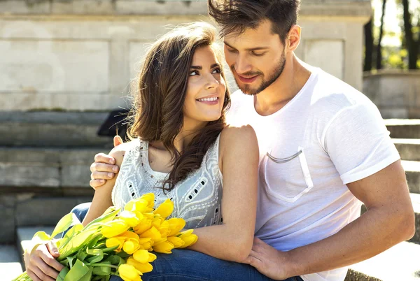 Attractive couple with yellow tulips