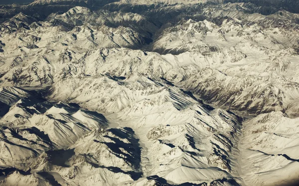 Mountain range, beautiful snowy mountains. View from the airplan
