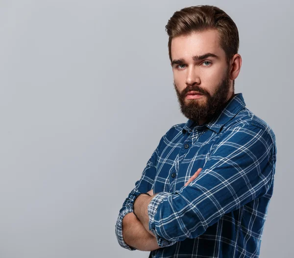 Bearded man in checkered shirt