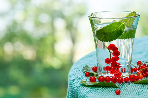 Drink with red currant on the table