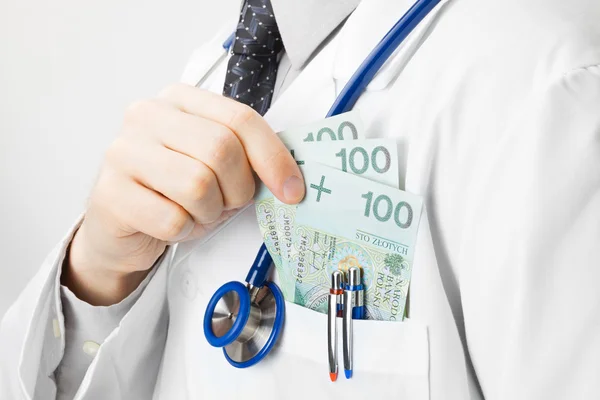 Doctor putting money into his pocket