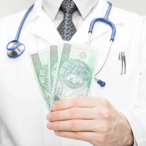 Medical doctor holding money in his hand - 1 to 1 ratio