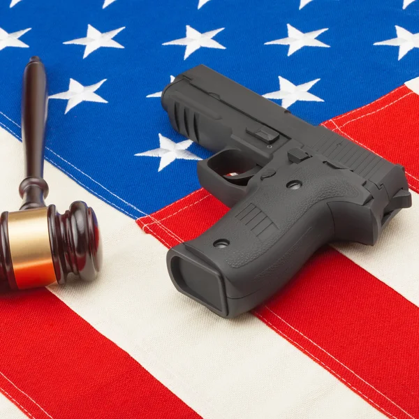 Judge gavel and gun over USA flag - self-defense law concept