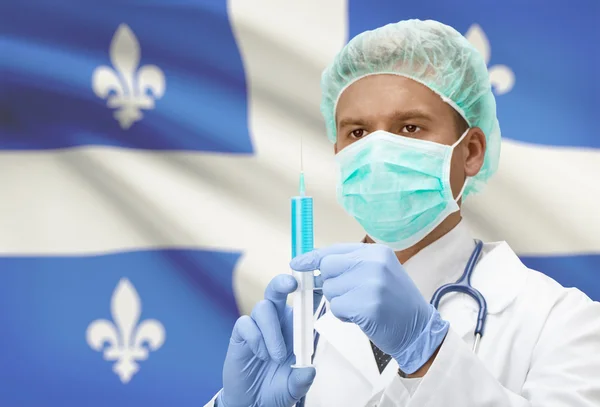 Doctor with syringe in hands and Canadian province flag on background series - Quebec