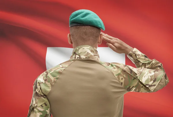 Dark-skinned soldier with flag on background - Switzerland