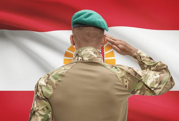 Dark-skinned soldier with flag on background - French Polynesia