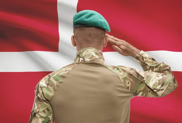 Dark-skinned soldier with flag on background - Denmark