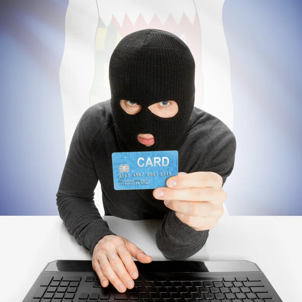 Hacker with credit card in hand and Canadian province flag - Northwest Territories