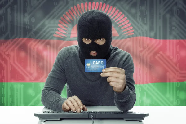 Dark-skinned hacker with flag on background holding credit card - Malawi