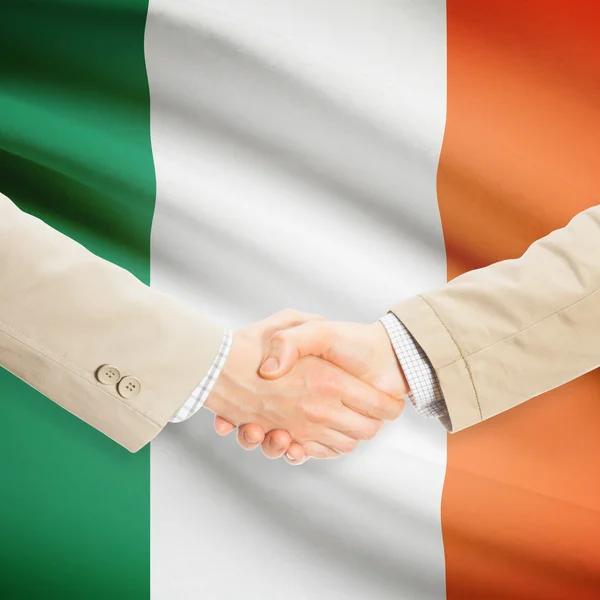 Businessmen handshake with flag on background - Ireland