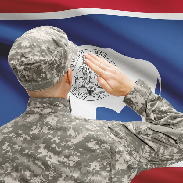 Soldier saluting to US state flag series - Wyoming