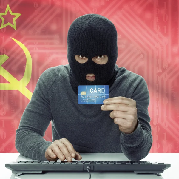 Dark-skinned hacker with flag on background holding credit card in hand - USSR - Soviet Union