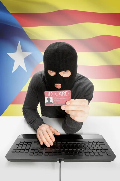 Hacker with flag on background holding ID card in hand - Estelada - Catalonia