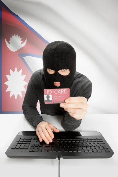 Hacker with flag on background holding ID card in hand - Nepal