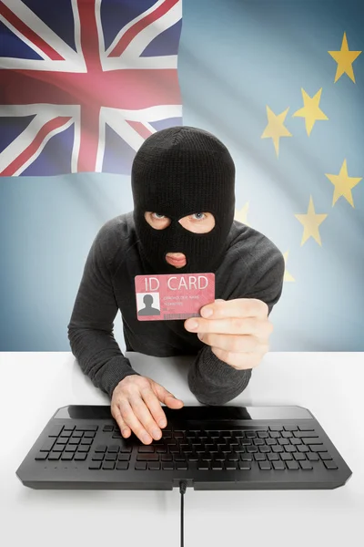 Hacker with flag on background holding ID card in hand - Tuvalu