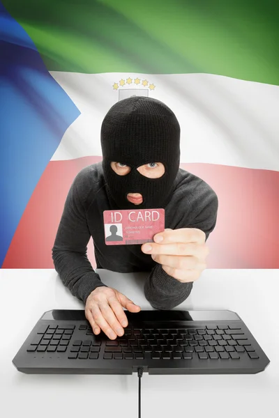 Hacker with flag on background holding ID card in hand - Equatorial Guinea