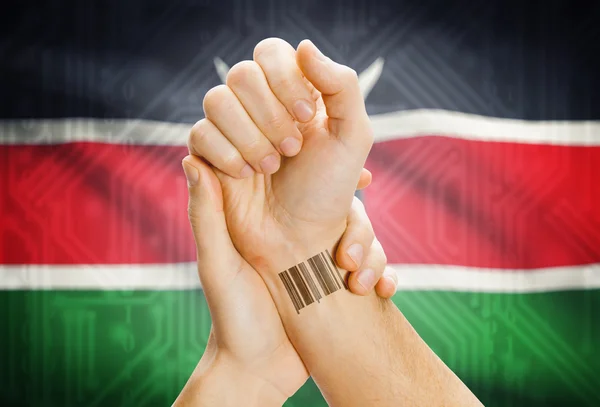 Barcode ID number on wrist and national flag on background - Kenya