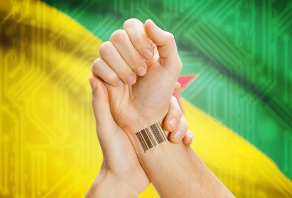 Barcode ID number on wrist and national flag on background - French Guiana