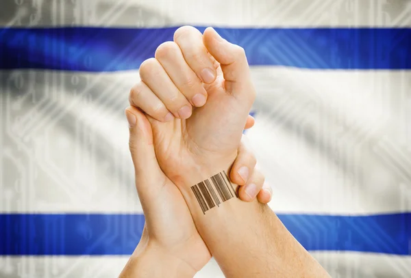 Barcode ID number on wrist and national flag on background - Israel