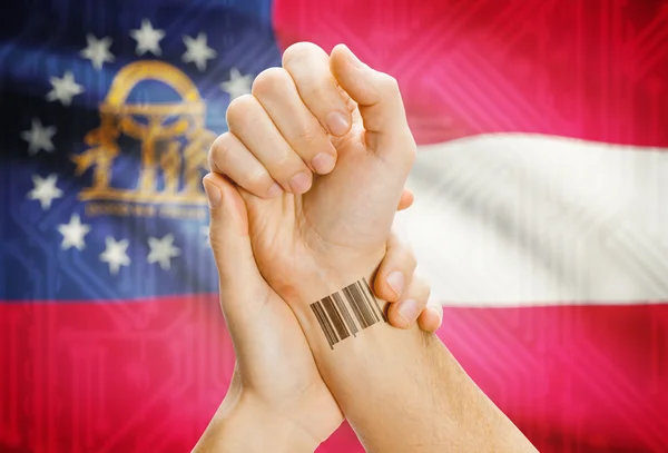Barcode ID number on wrist and USA states flags on background - Georgia
