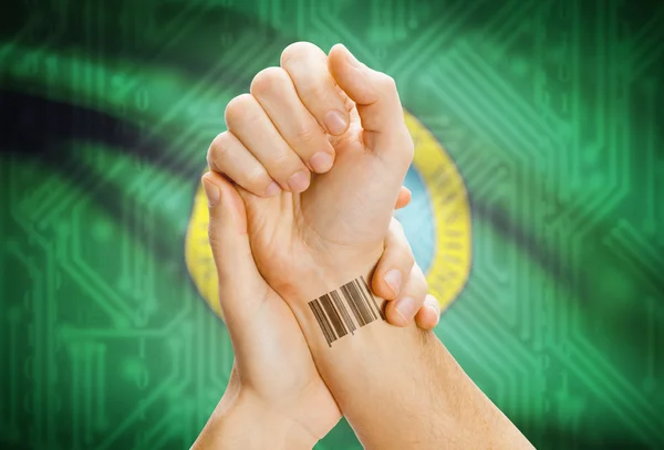 Barcode ID number on wrist and USA states flags on background - Washington