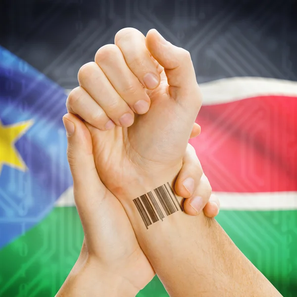 Barcode ID number on wrist and national flag on background series - South Sudan