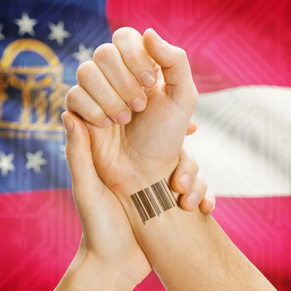 Barcode ID number on wrist and USA states flags on background series - Georgia