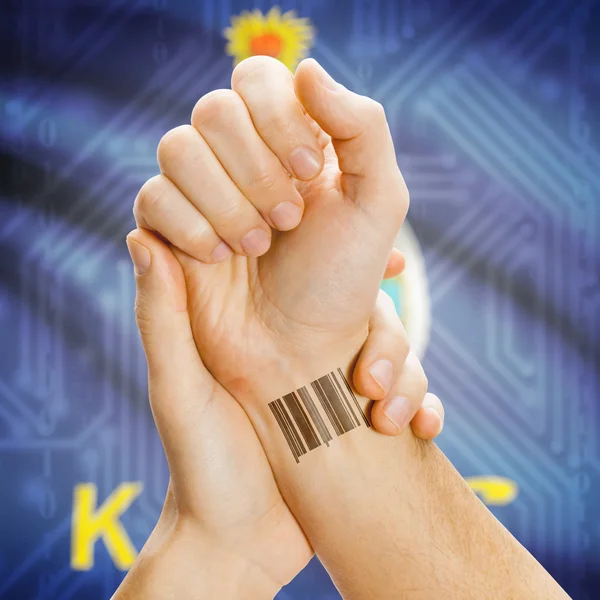 Barcode ID number on wrist and USA states flags on background series - Kansas