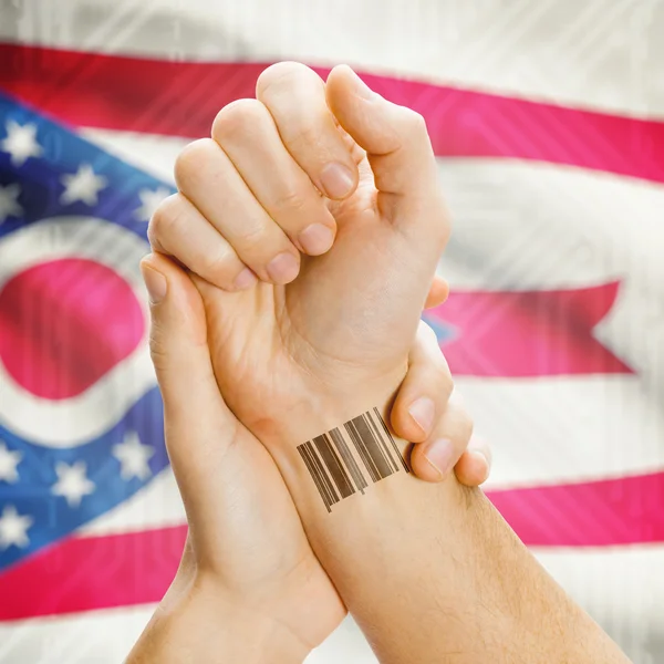 Barcode ID number on wrist and USA states flags on background series - Ohio