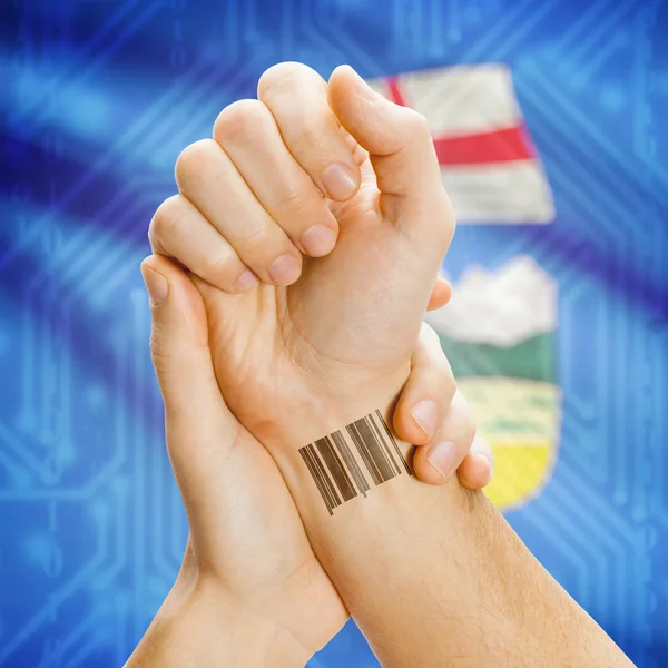 Barcode ID number on wrist with Canadian province flag on background series - Alberta