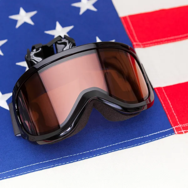 Winter sport goggles over USA flag - studio shot