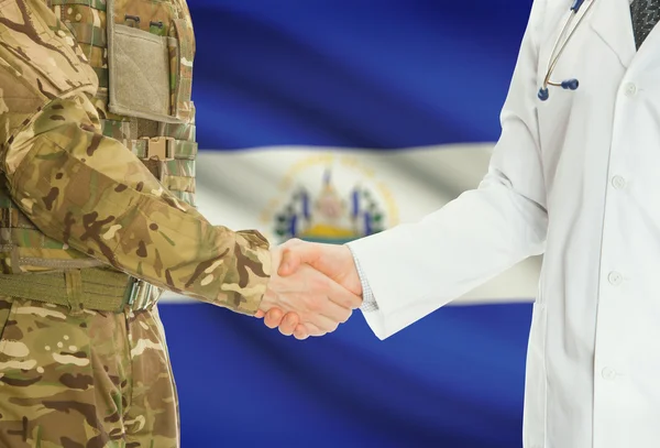 Military man in uniform and doctor shaking hands with national flag on background - El Salvador
