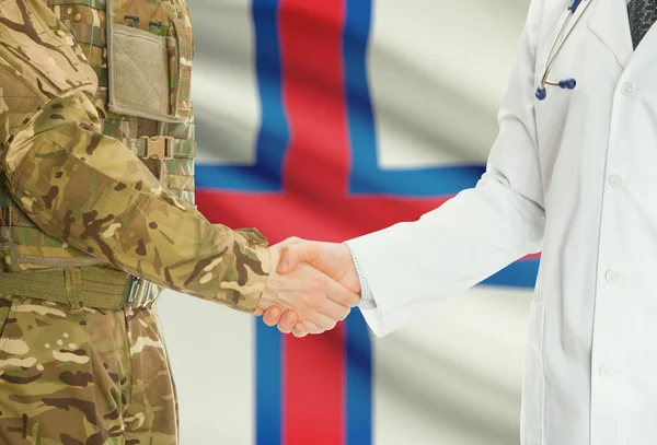 Military man in uniform and doctor shaking hands with national flag on background - Faroe Islands