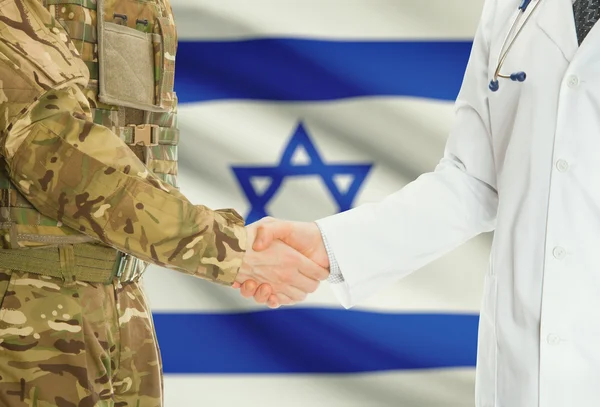 Military man in uniform and doctor shaking hands with national flag on background - Israel