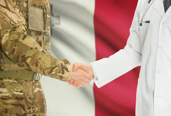 Military man in uniform and doctor shaking hands with national flag on background - Malta