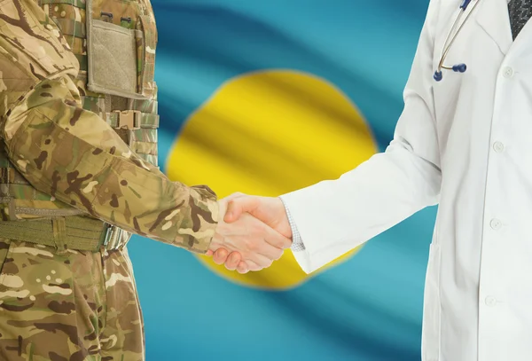 Military man in uniform and doctor shaking hands with national flag on background - Palau