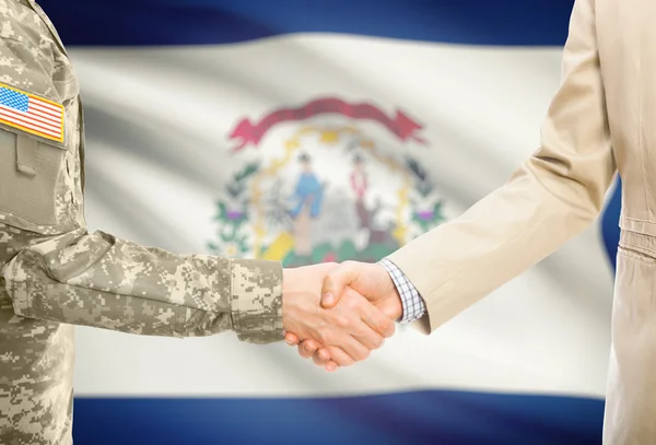 USA military man in uniform and civil man in suit shaking hands with USA state flag on background - West Virginia