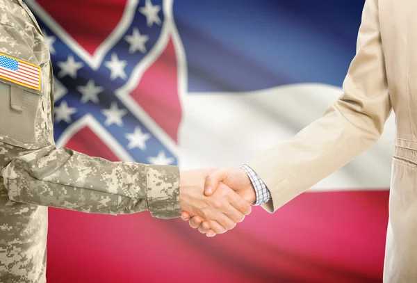 USA military man in uniform and civil man in suit shaking hands with USA state flag on background - Mississippi