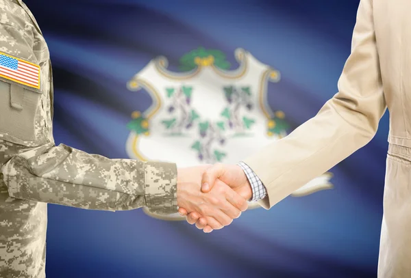 USA military man in uniform and civil man in suit shaking hands with USA state flag on background - Connecticut
