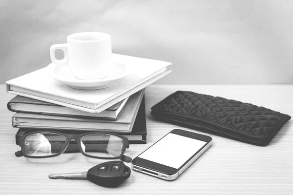 Coffee and phone with stack of book,car key,eyeglasses and walle