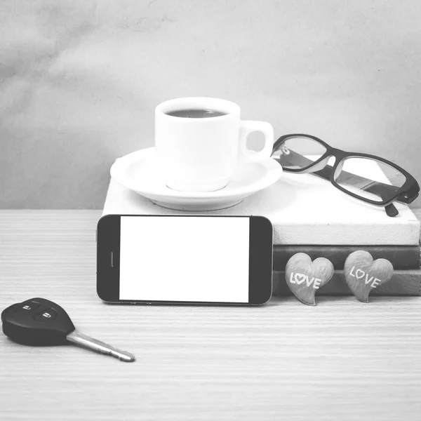 Office desk : coffee and phone with car key,eyeglasses,stack of