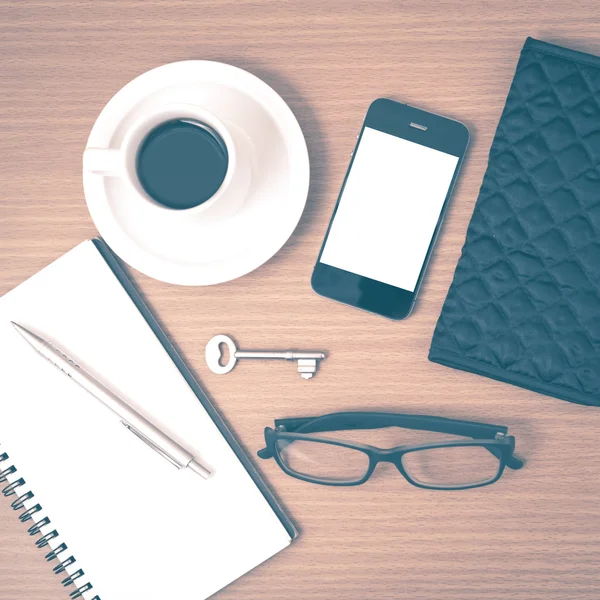 Coffee and phone with notepad,key,eyeglasses and wallet vintage