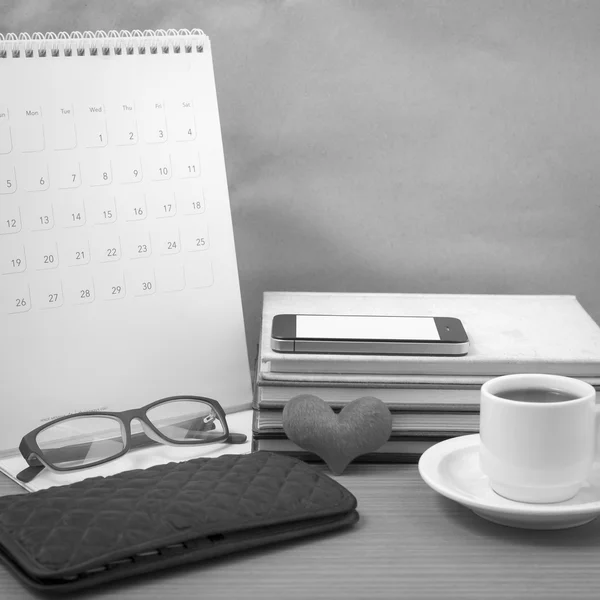 Desktop : coffee with phone,stack of book,wallet,heart,eyeglasse