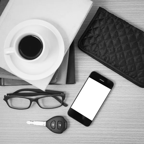 Coffee and phone with stack of book,car key,eyeglasses and walle